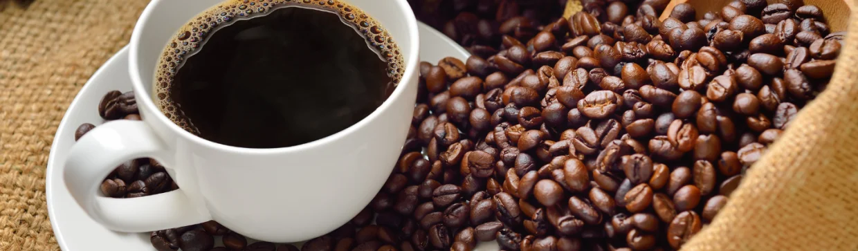 Freshly brewed coffee with roasted beans