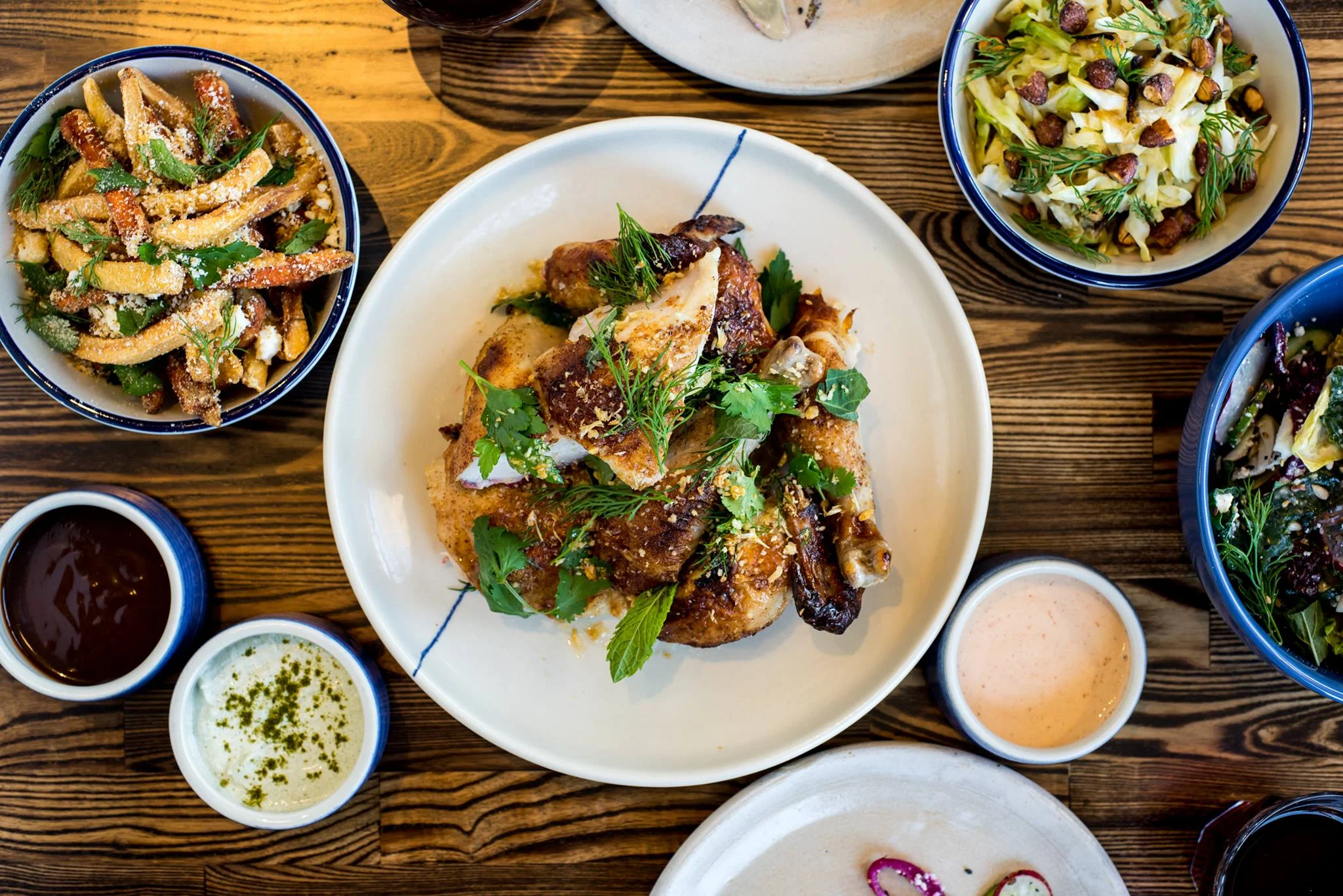 Herb-roasted chicken with sides in a vibrant restaurant setting