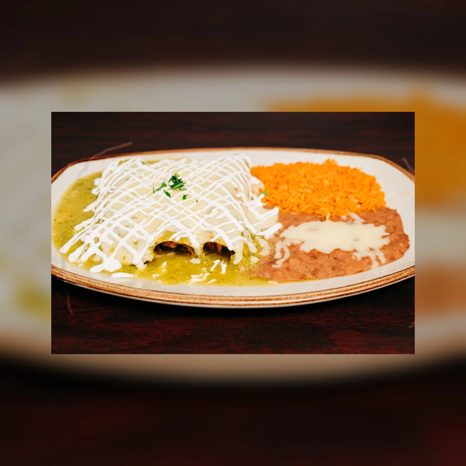 Plate of enchiladas verdes with rice and beans