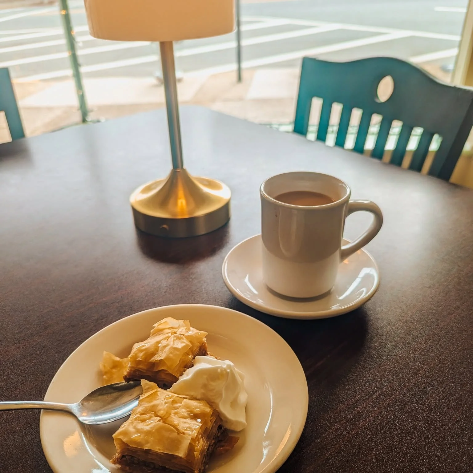Turkish baklava with whipped cream and coffee