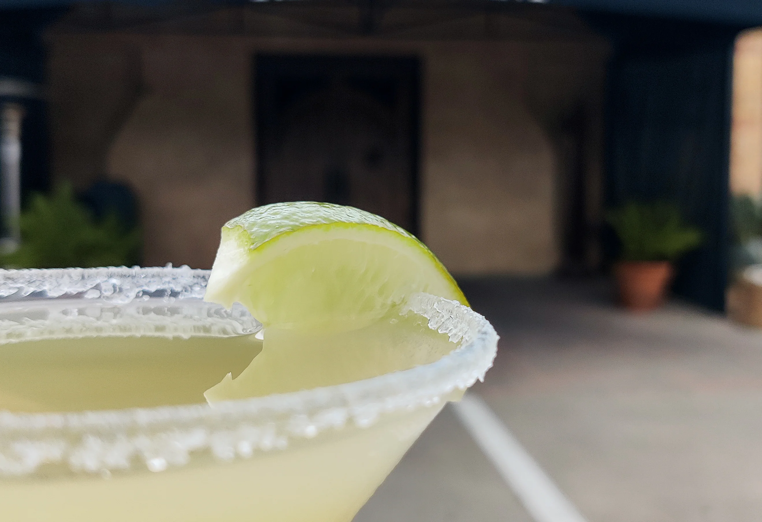 Refreshing margarita cocktail with lime at a restaurant entrance