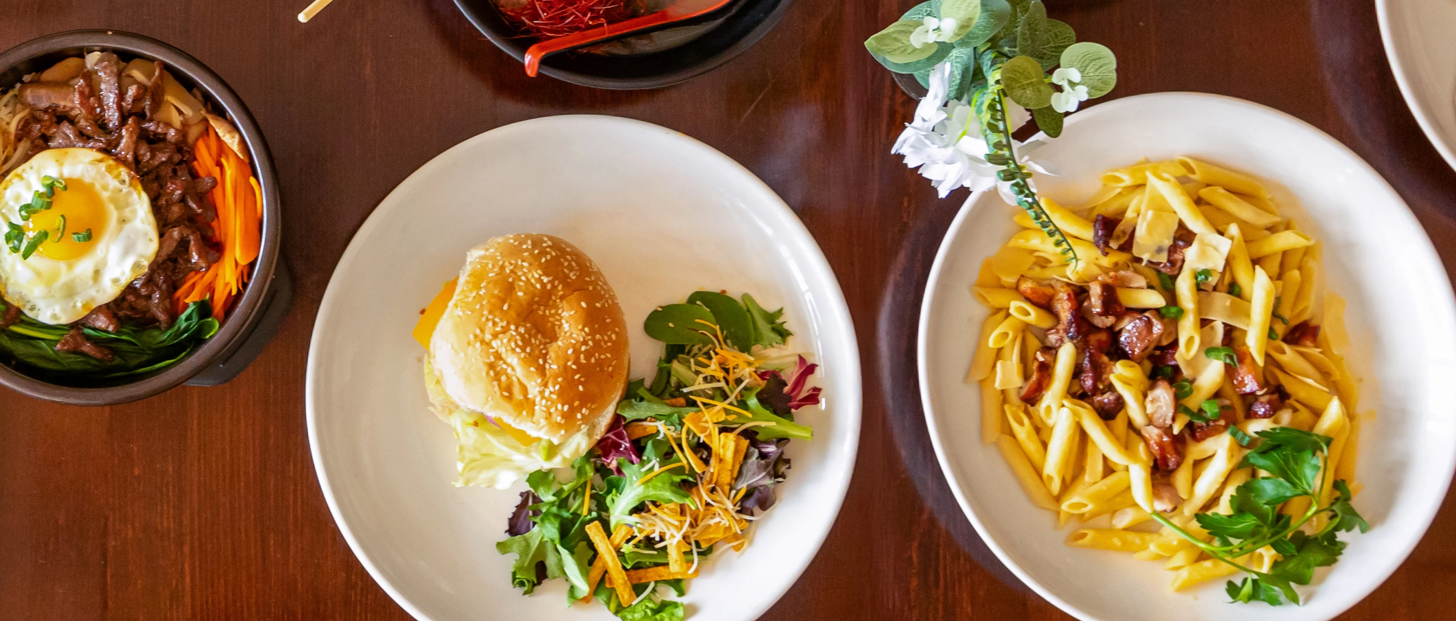 Variety of Asian fusion dishes including ramen and stir-fried noodles