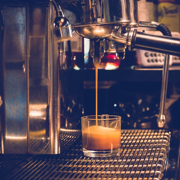 Espresso pouring from a coffee machine into a glass
