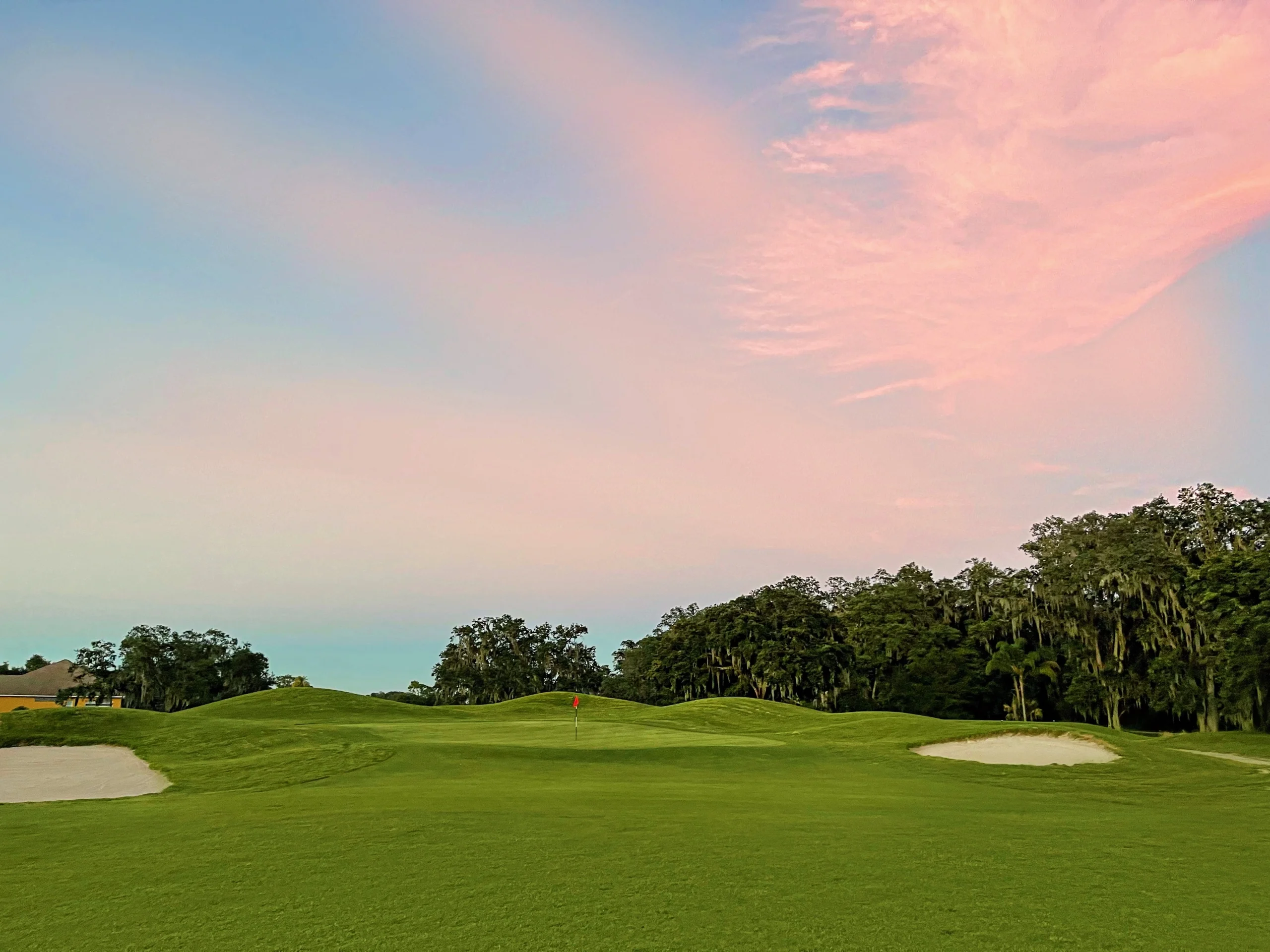 Scenic golf course at sunset with lush green fairways