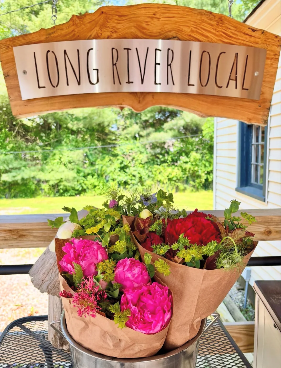 Flower bouquets at Long River Local restaurant entrance