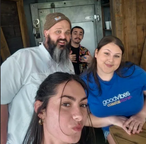 Staff posing together at a coastal kitchen restaurant