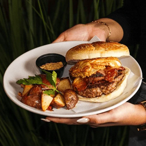 A breakfast burger and potatoes