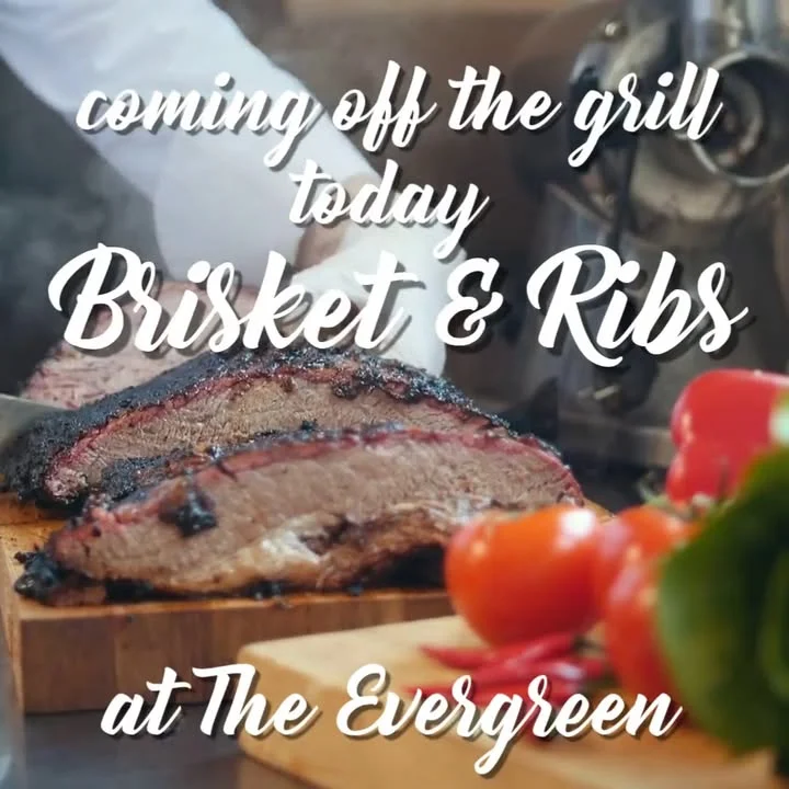 Smoked brisket and ribs served on a wooden cutting board