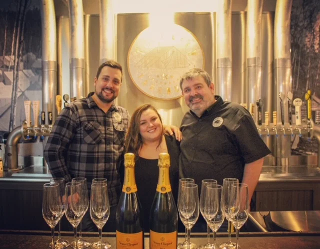 Celebration at a brewery with champagne and glasses