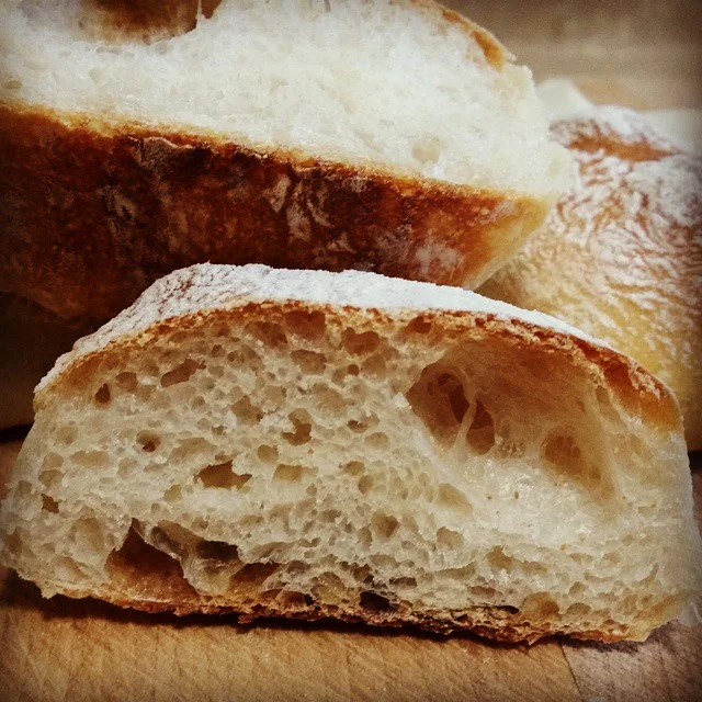 Freshly baked sourdough bread, called Garda rolls.