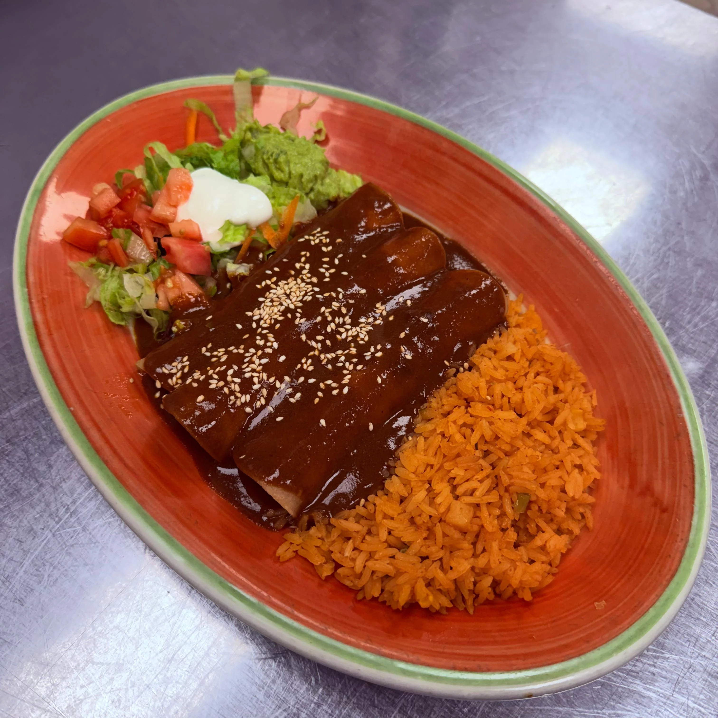 Mexican enchiladas with mole sauce and rice