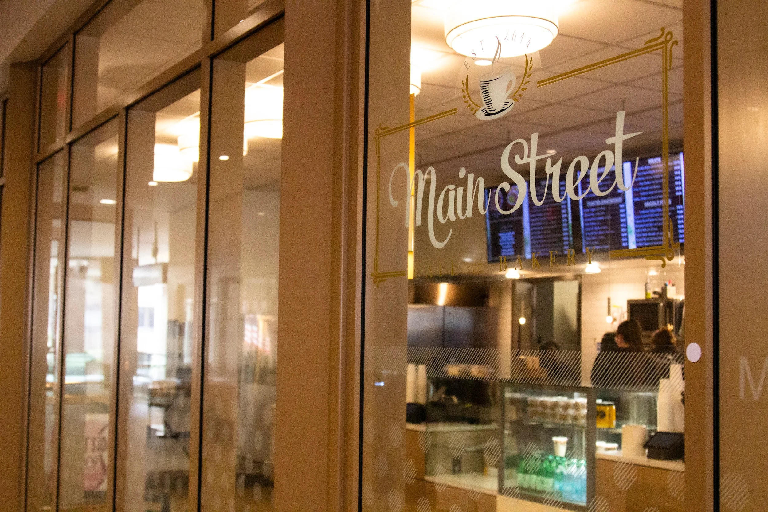 Cozy café entrance with modern decor and menu display