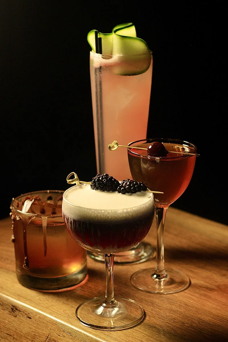 Assorted cocktails including a blackberry drink and a cucumber spritz