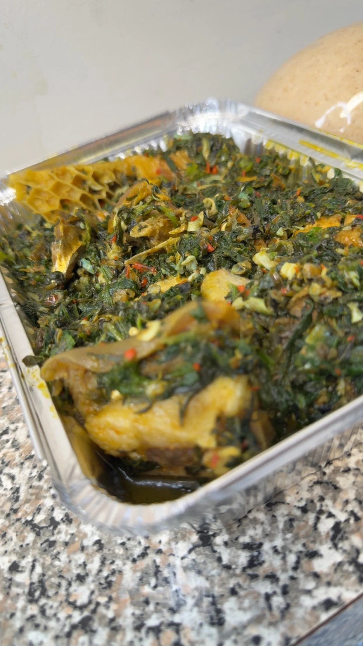 Nigerian egusi soup with fish and vegetables