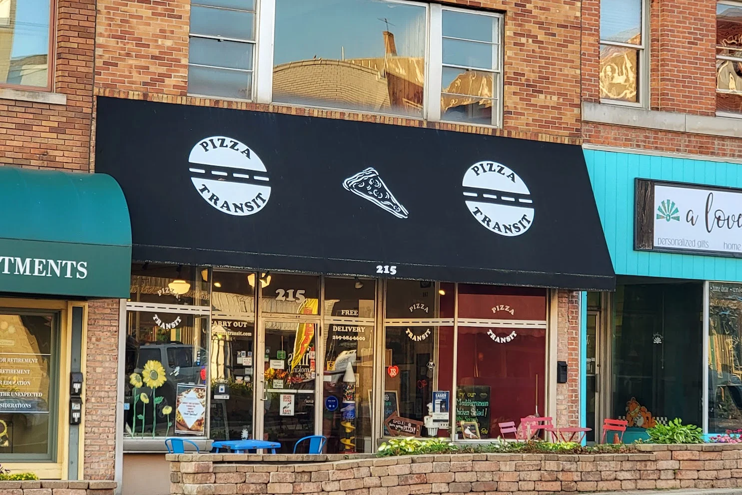 Pizza Transit restaurant exterior with black awning