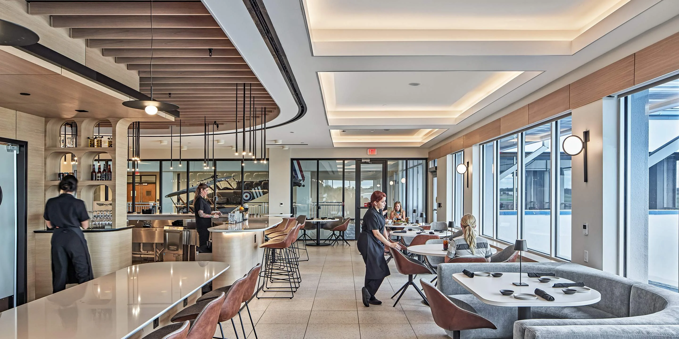 Modern restaurant interior with stylish decor and large windows