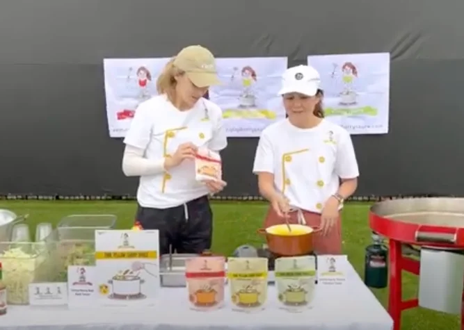 Culinary demonstration with chefs preparing dishes outdoors