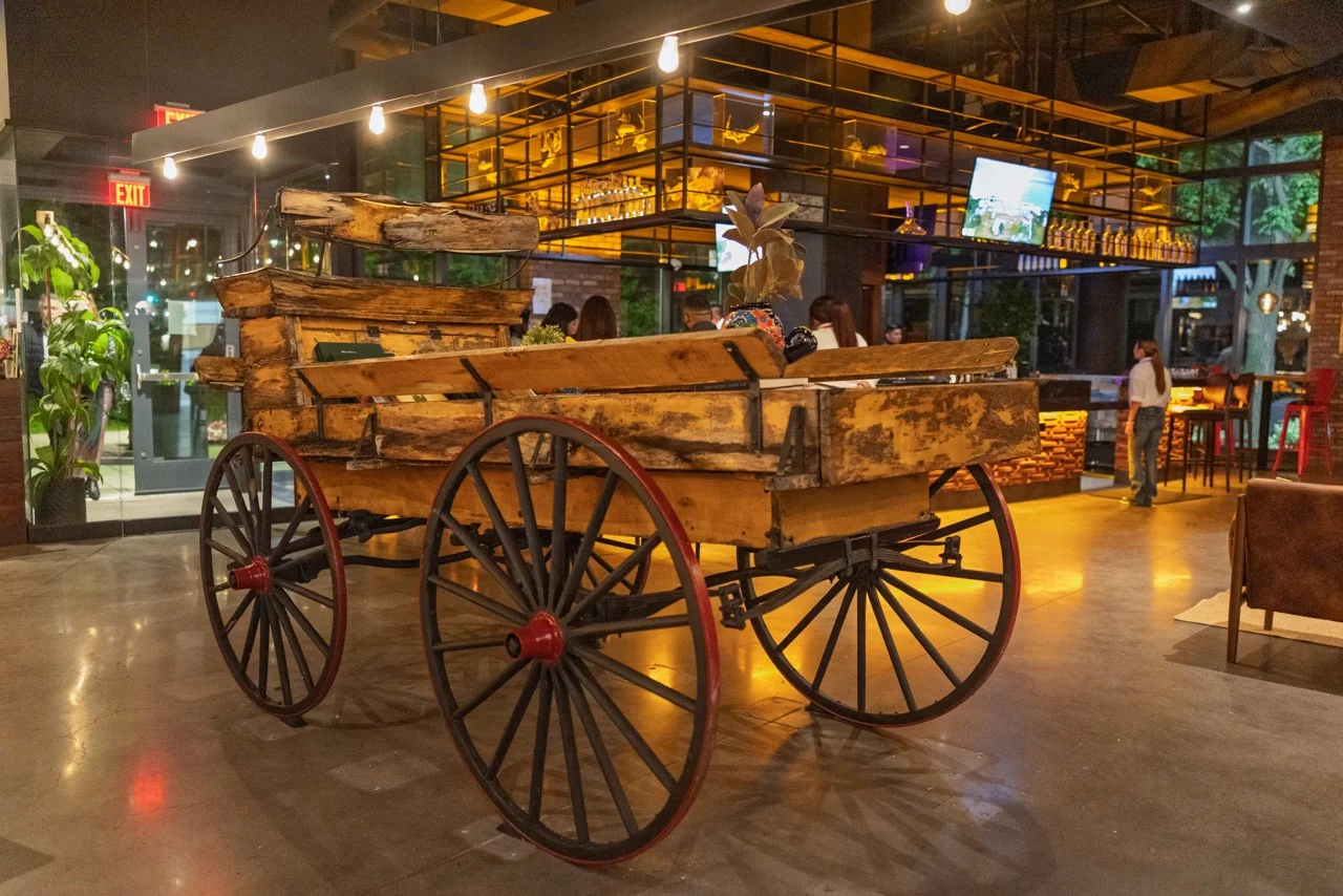 Wooden cart centerpiece in a modern restaurant interior.