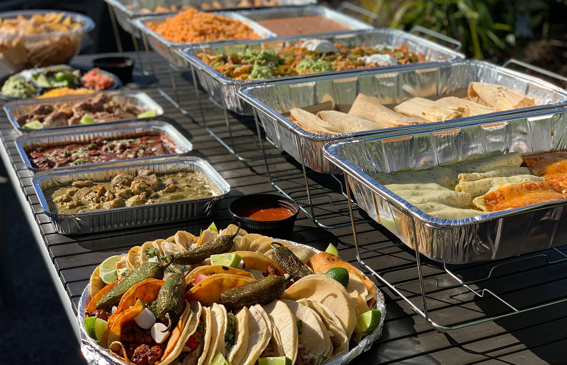 Mexican food catering table with tacos and different dishes