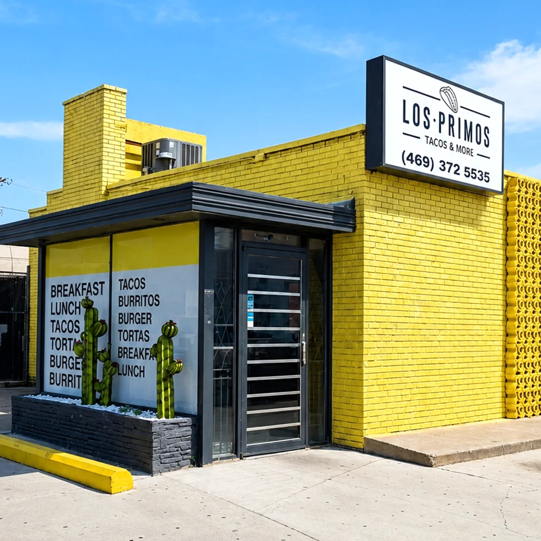 Exterior of Los Primos Tacos restaurant with bright yellow walls