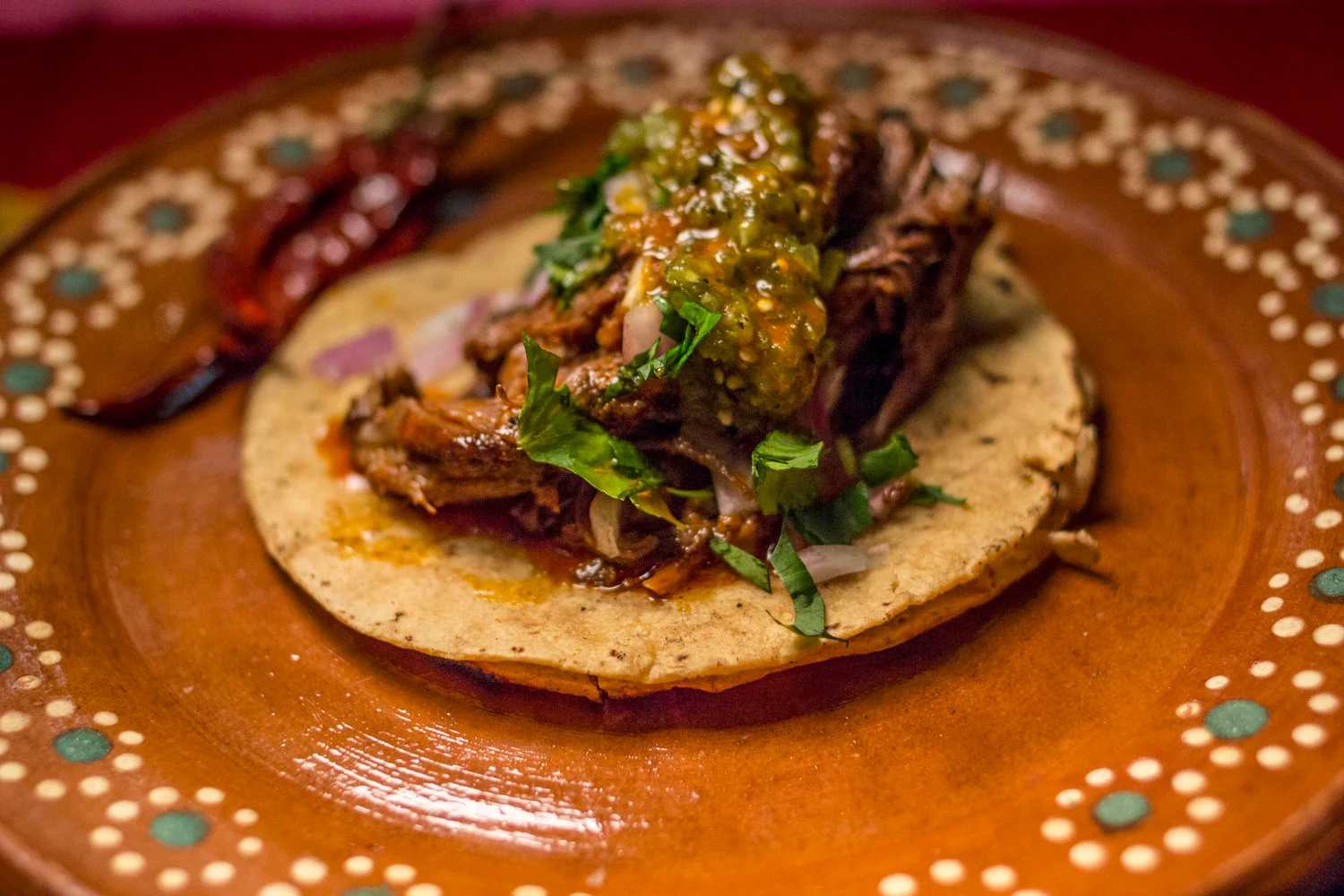 Authentic Mexican taco with slow-cooked beef and salsa verde