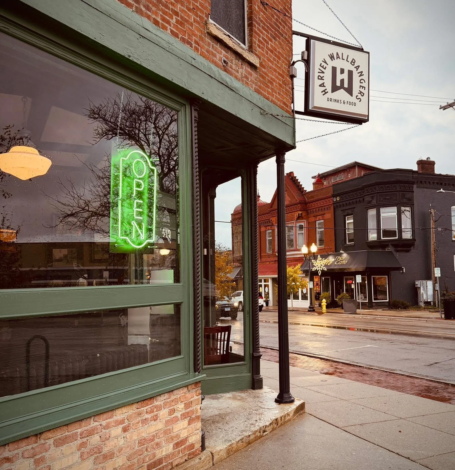 Charming restaurant exterior with an open sign and vintage brick facade
