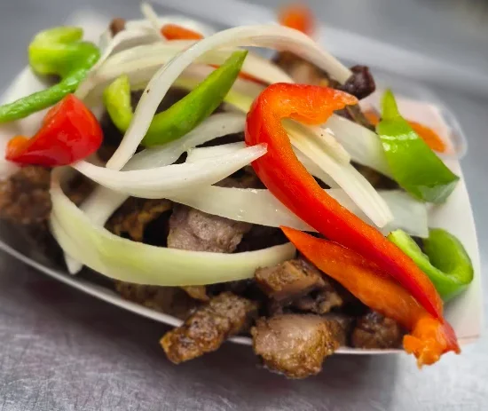 Delicious Mexican carne asada topped with fresh vegetables