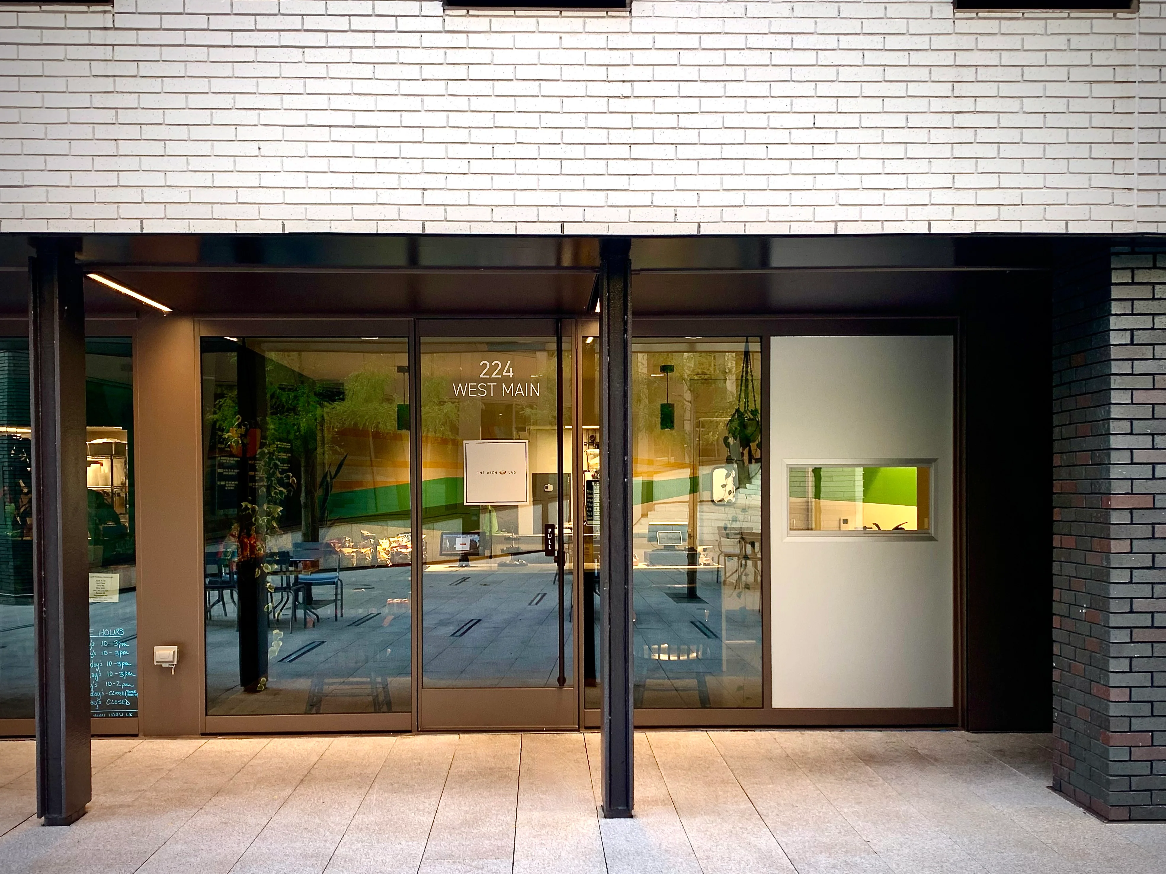 Modern restaurant entrance with glass doors and minimalist design