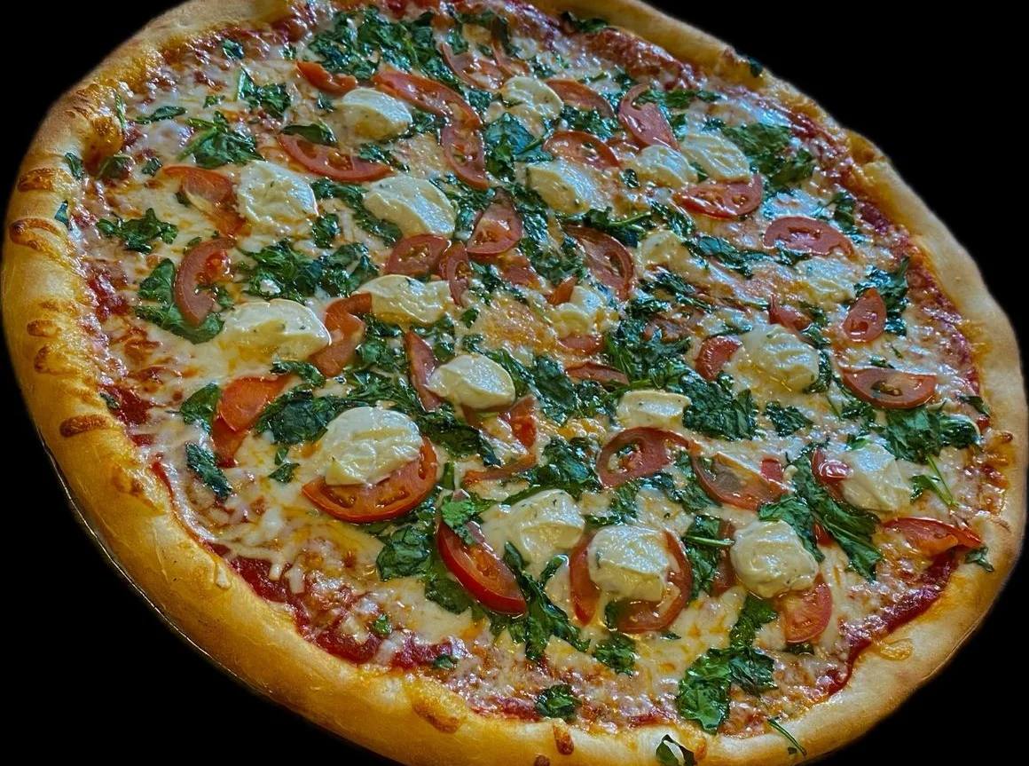 Delicious Margherita pizza topped with fresh basil and tomatoes