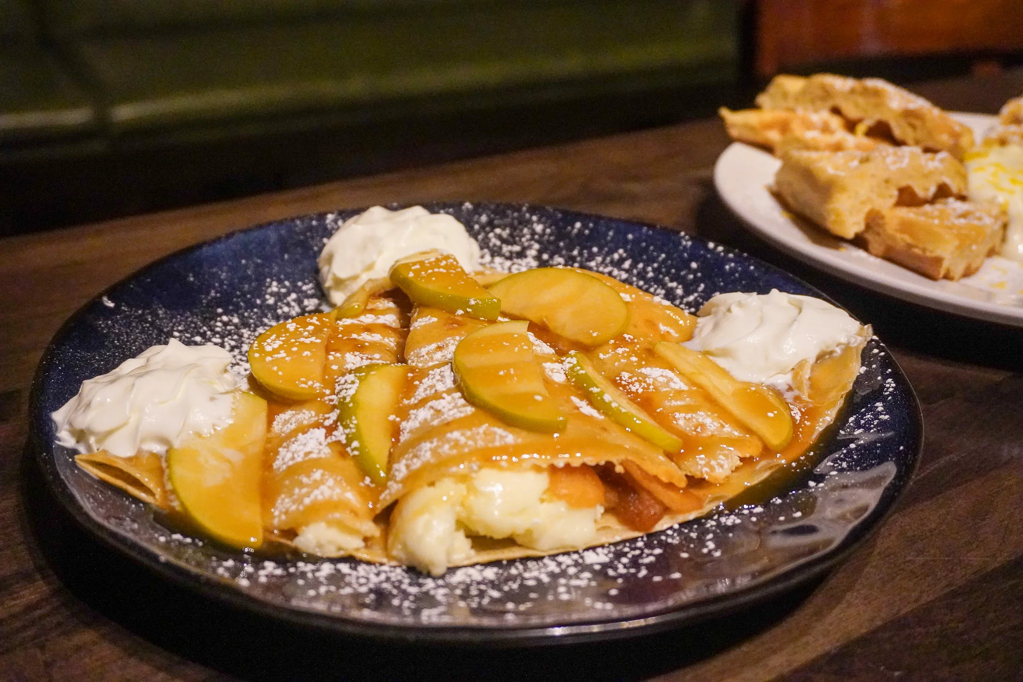 Delicious apple crepes with whipped cream and caramel sauce