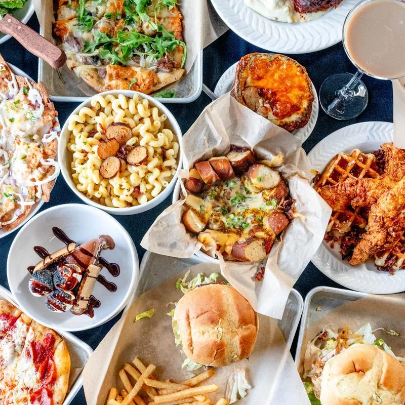 Assorted comfort food platter featuring fried chicken and burgers