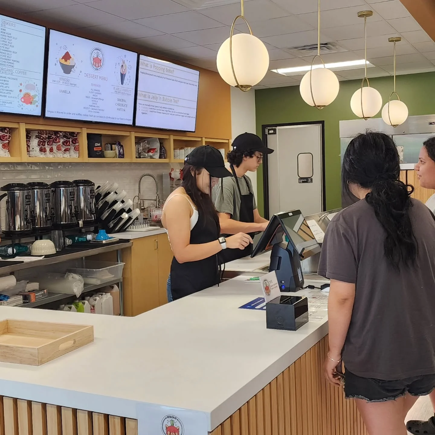 Modern café interior with staff serving customers
