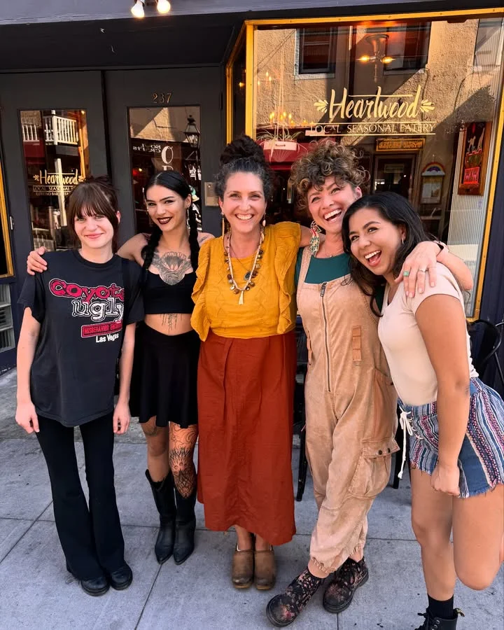 Group of restaurant staff smiling outside Heartwood eatery