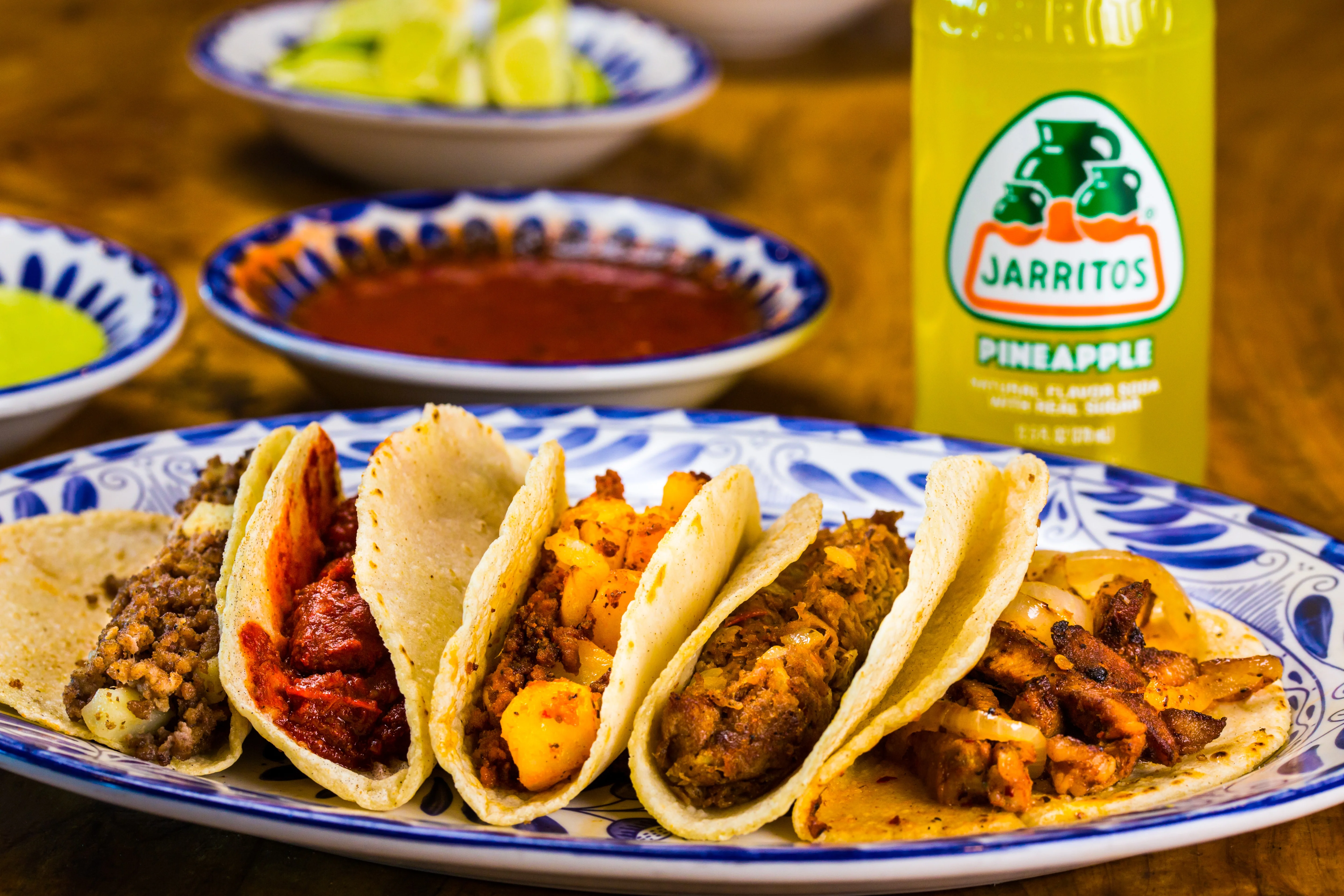 Assorted Mexican tacos with various fillings on a decorative plate