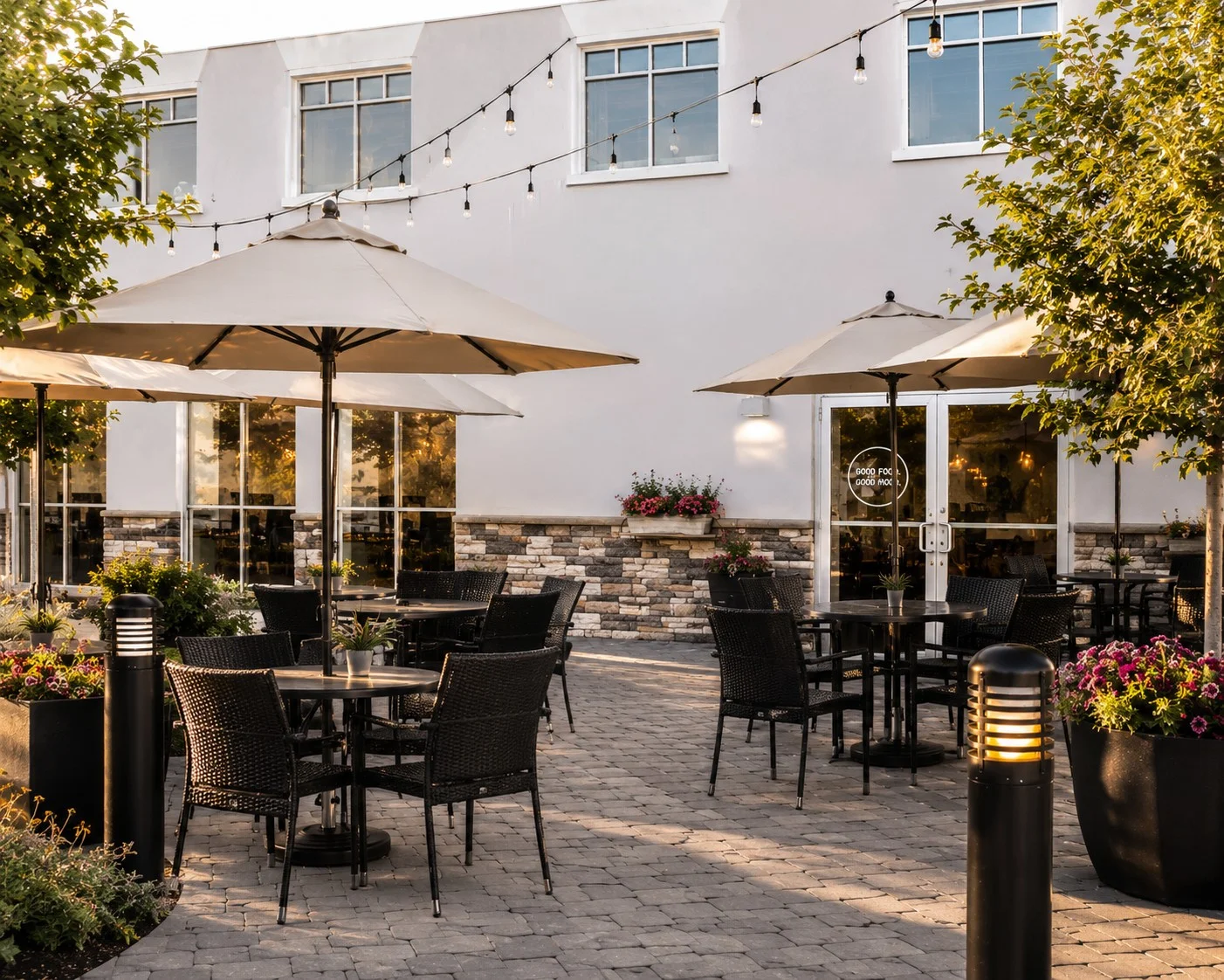 Charming outdoor dining area with umbrellas and string lights