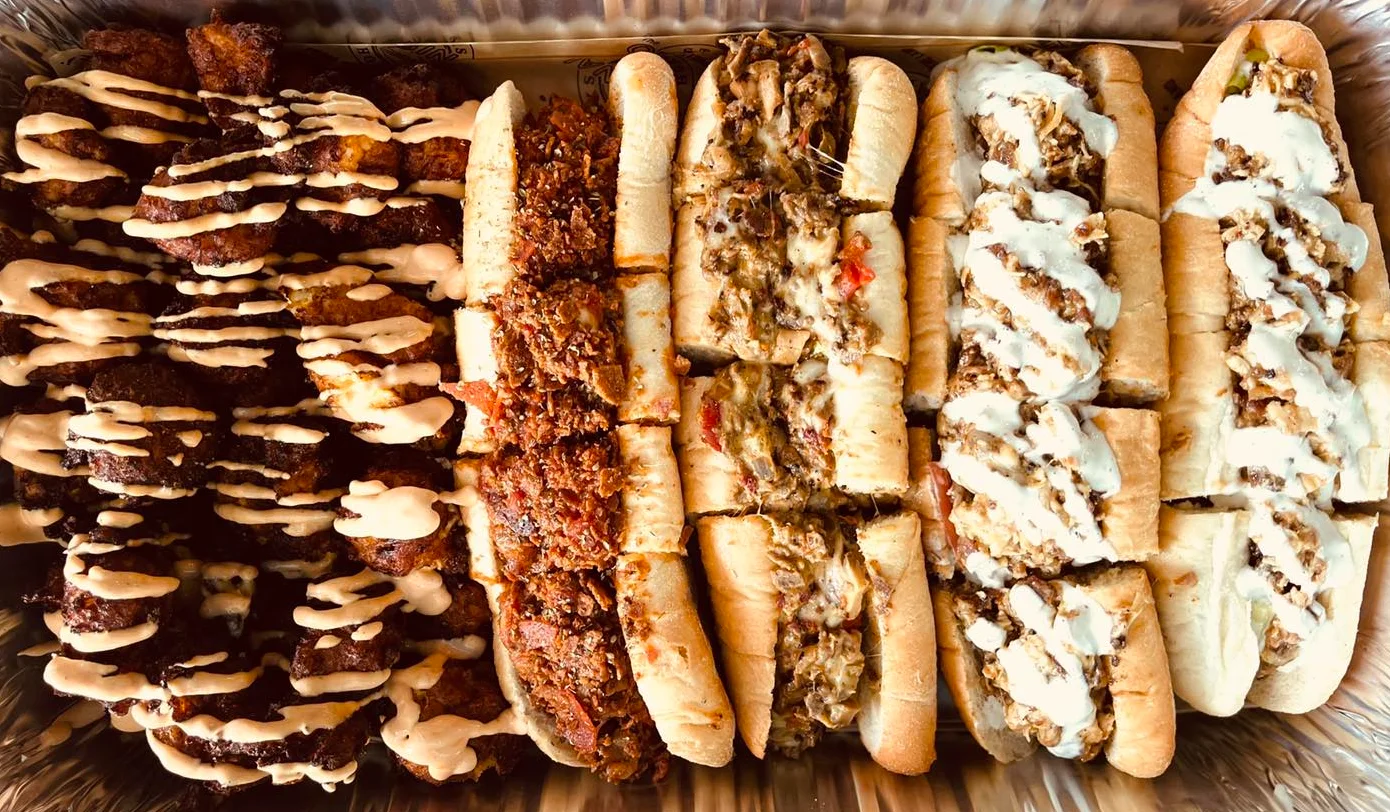 Assorted sandwiches and fried bites with sauces