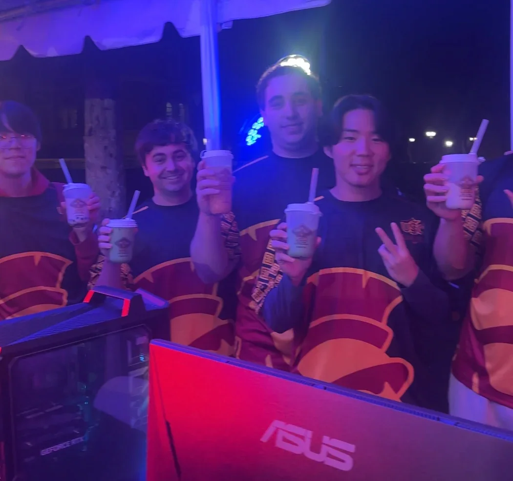 Group of gamers celebrating with drinks at an esports event