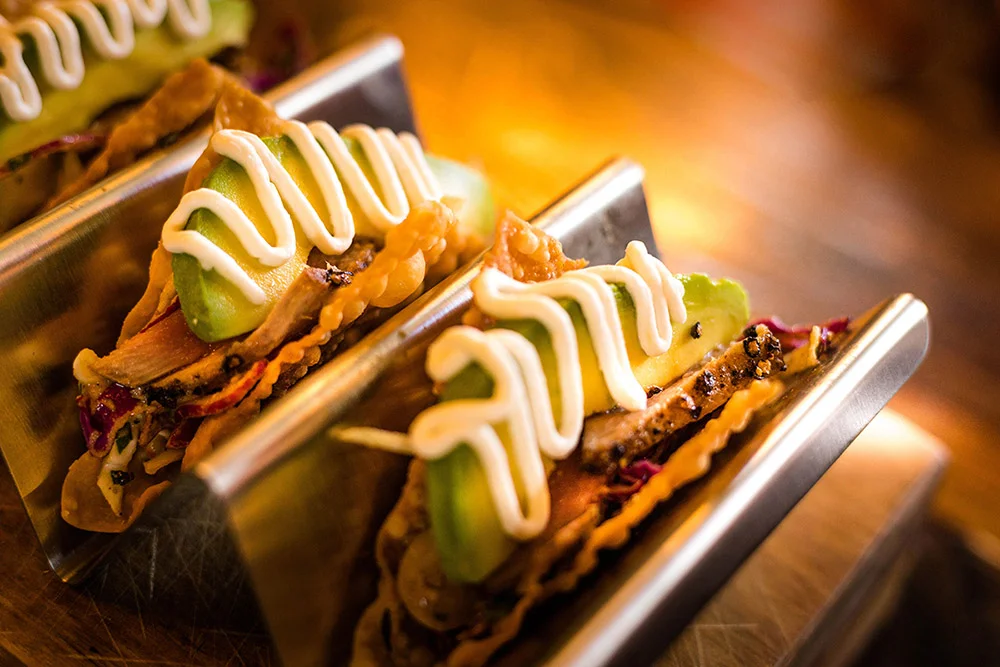 Gourmet tacos served in a metal holder