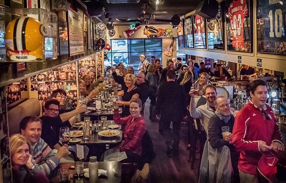Lively restaurant interior with guests enjoying drinks and food