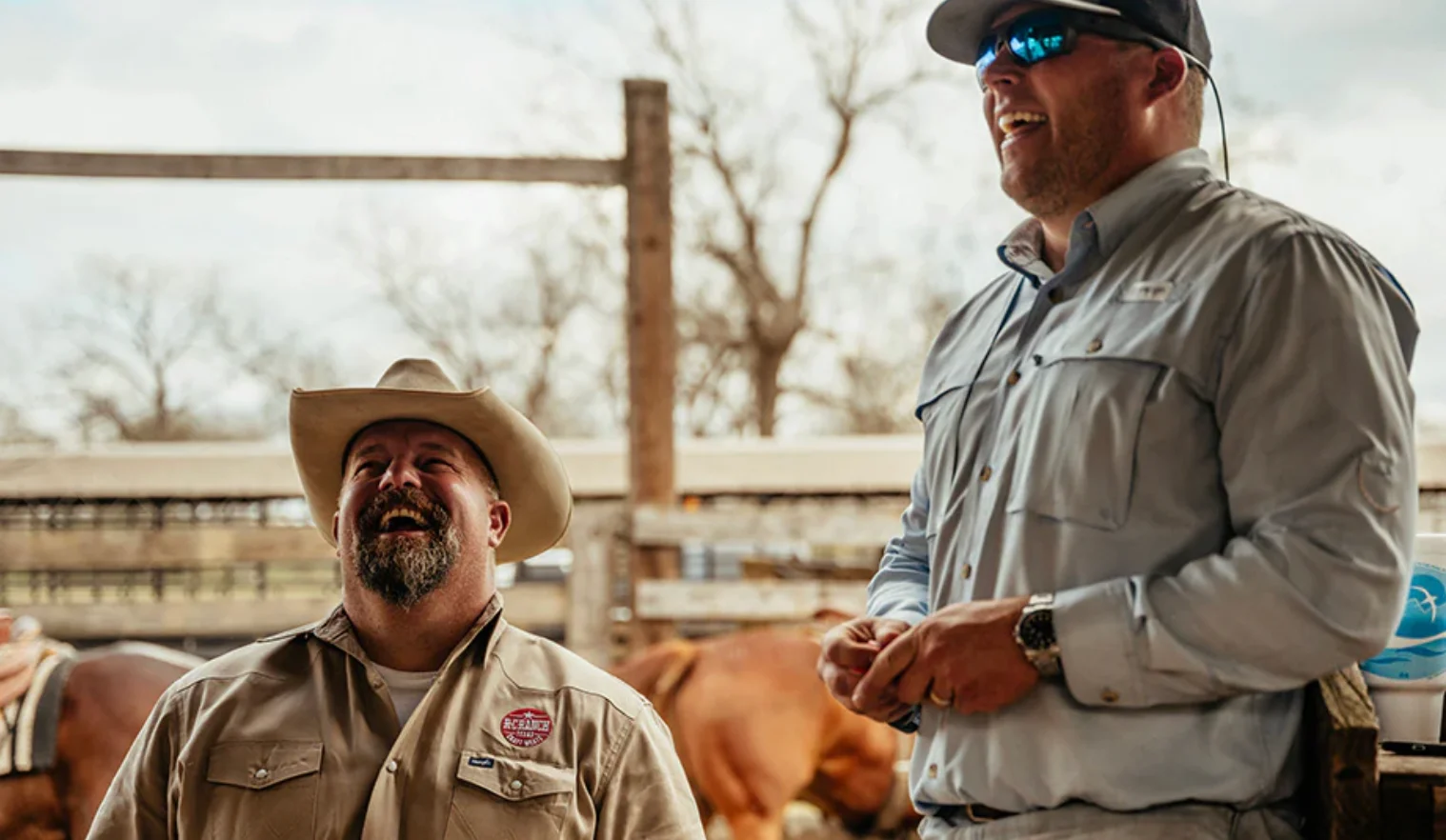 Three men in cowboy hats posing outdoors at a restaurant