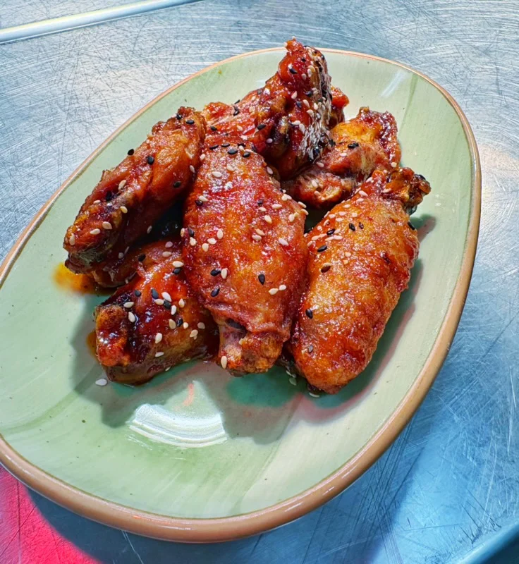 Crispy Korean fried chicken wings with sesame seeds