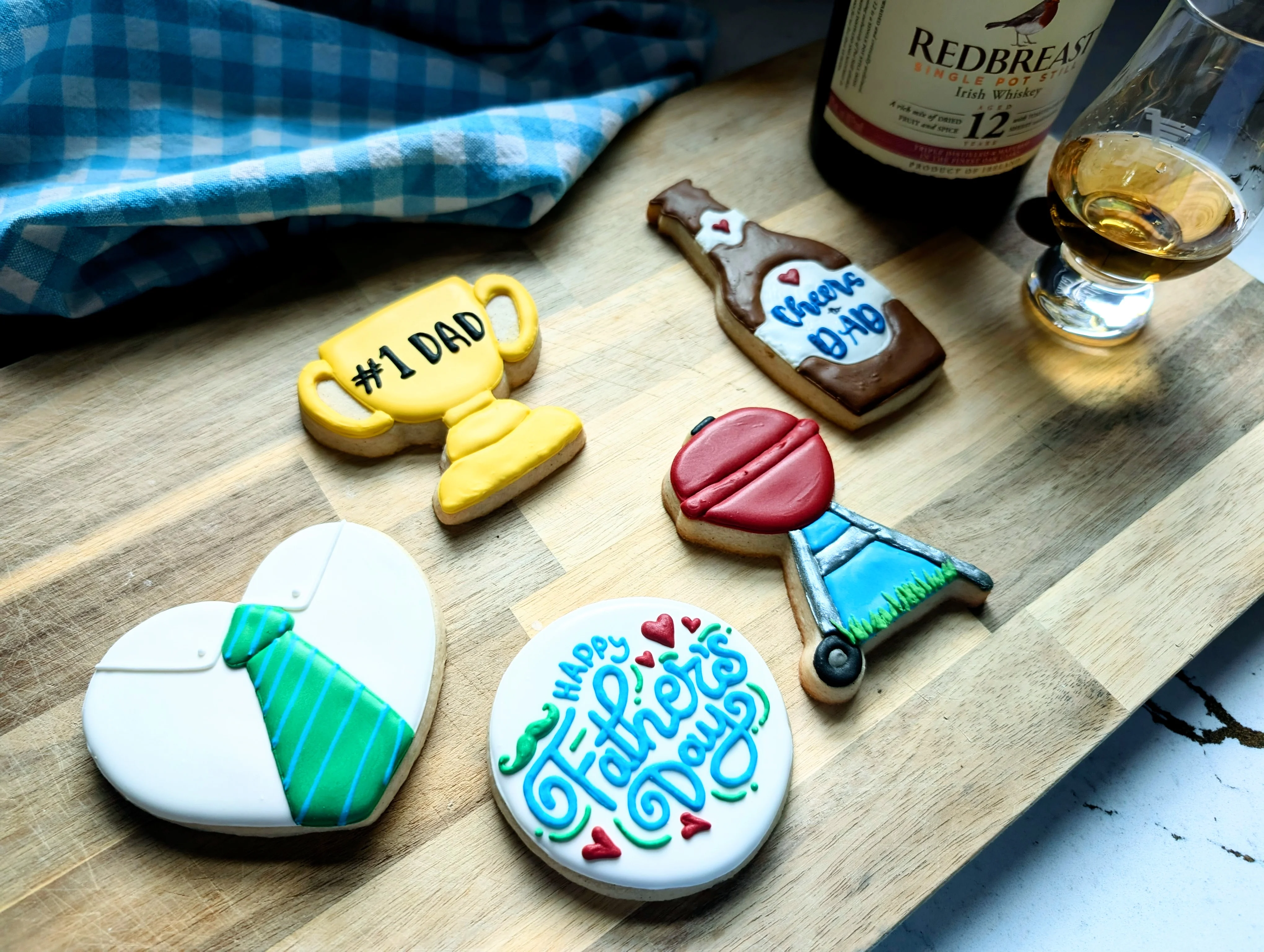 Decorative cookies for Father's Day with whiskey and a glass.