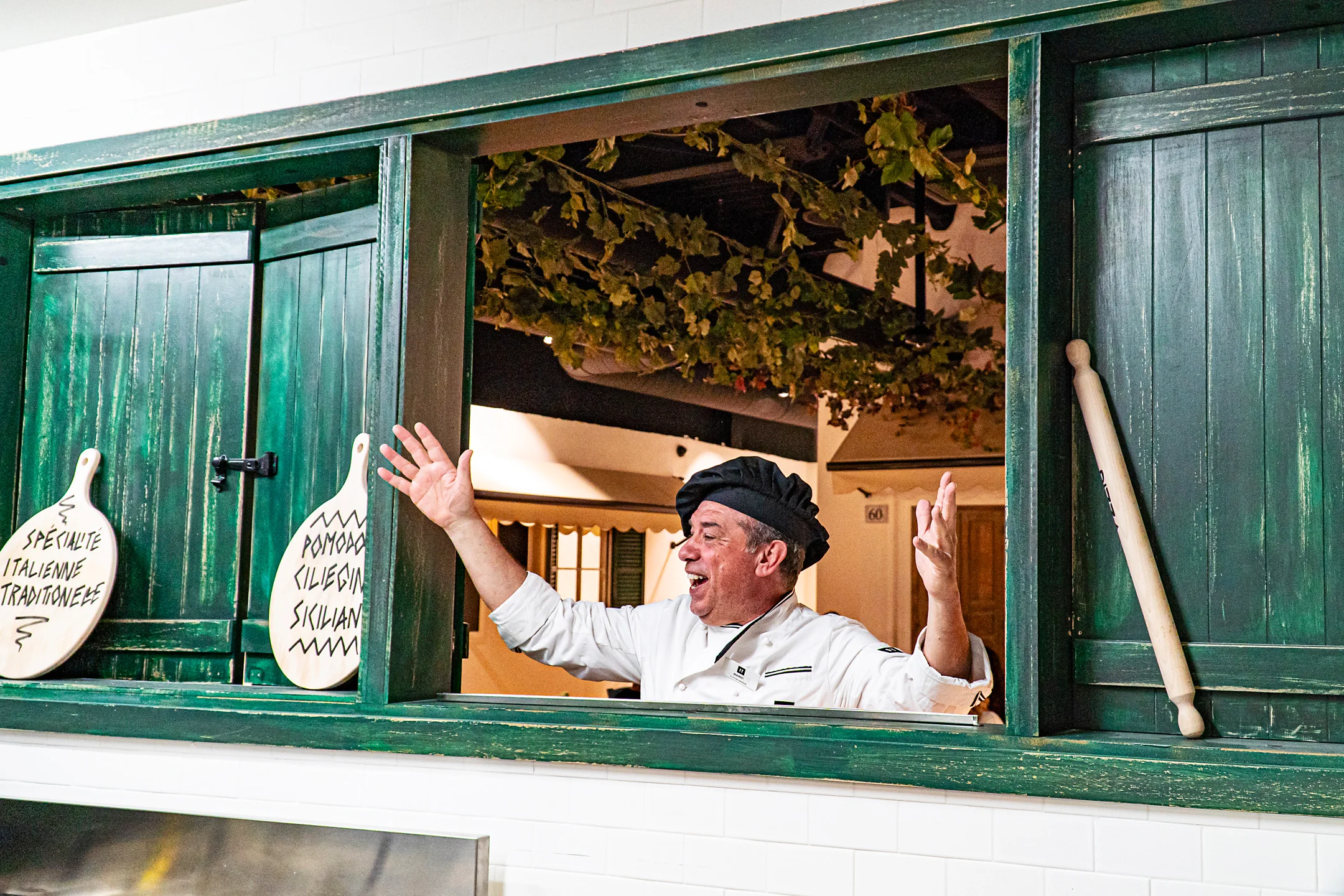 Chef welcoming guests in a vibrant Italian restaurant