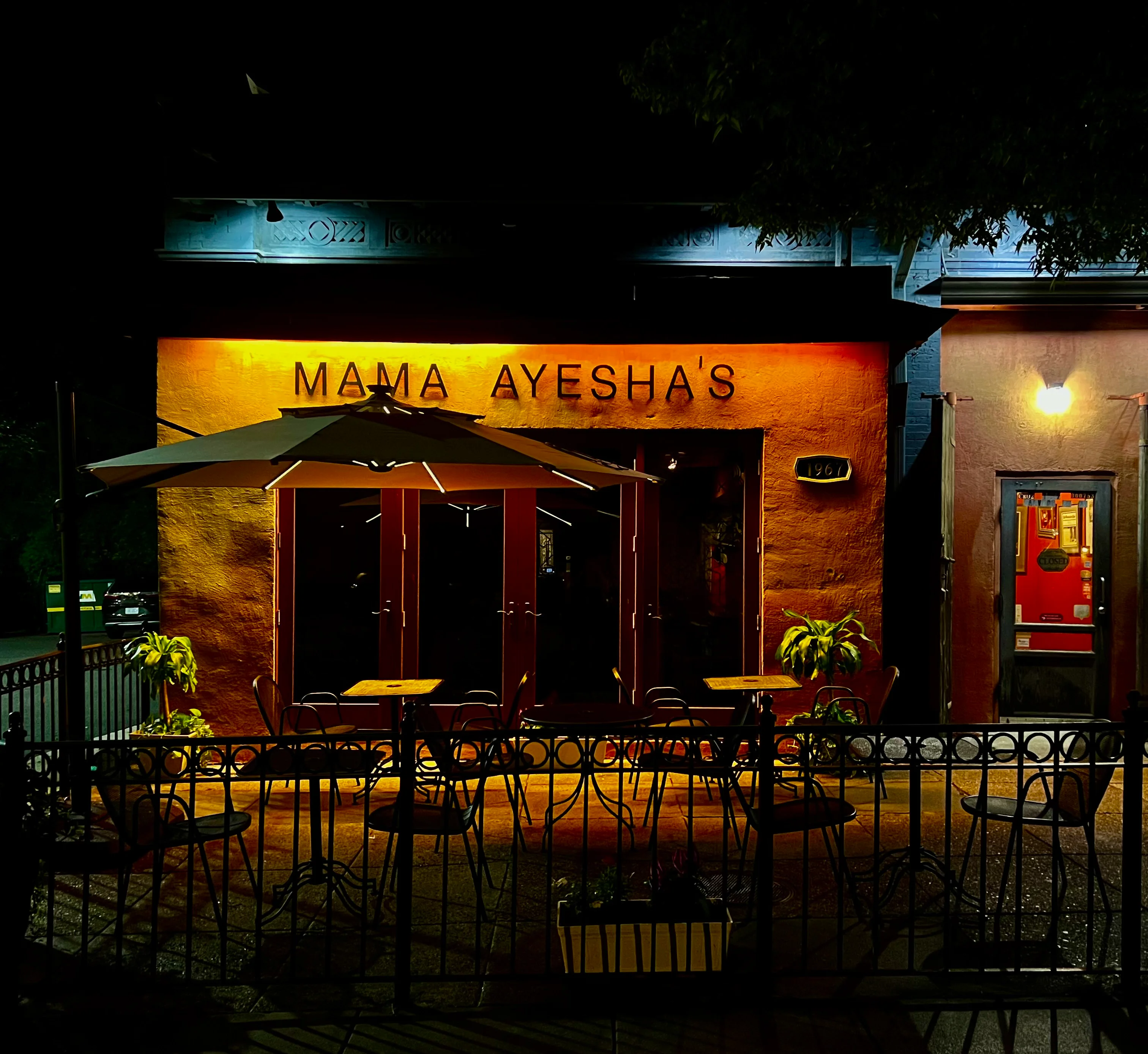 Charming restaurant exterior at night with warm lighting