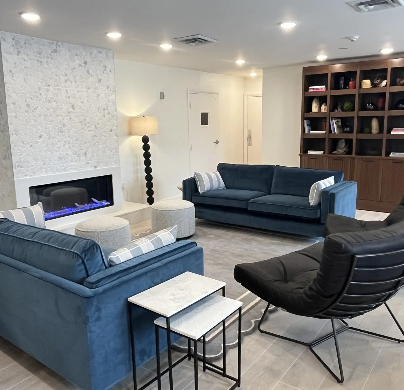 Hotel Manteo lobby with fireplace and lounge seating above Firetender restaurant