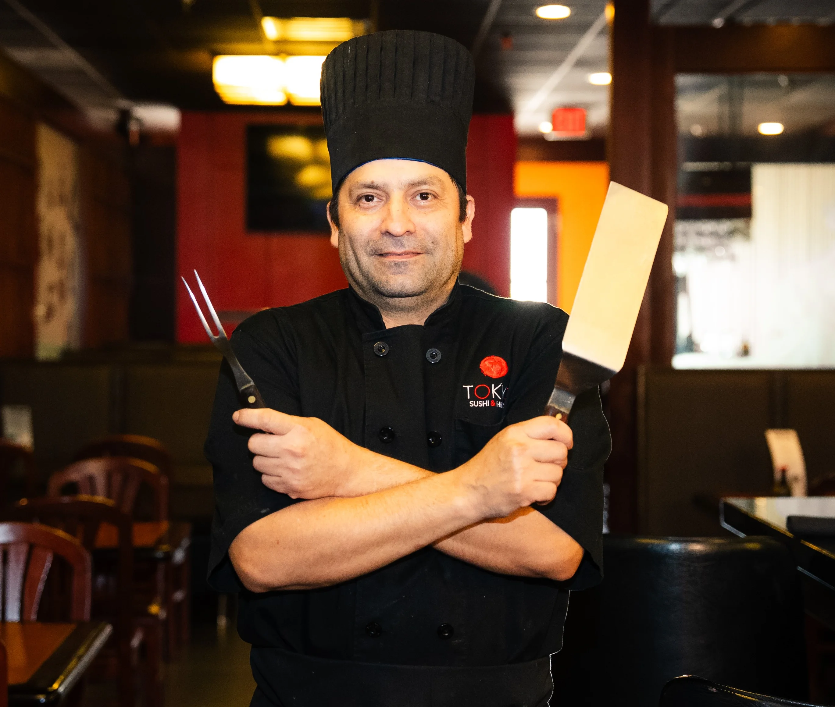 Chef in a Japanese restaurant with cooking tools