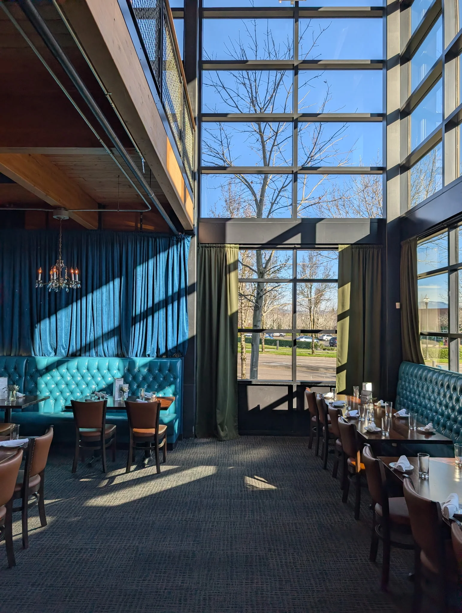 Modern restaurant interior with large windows and stylish seating