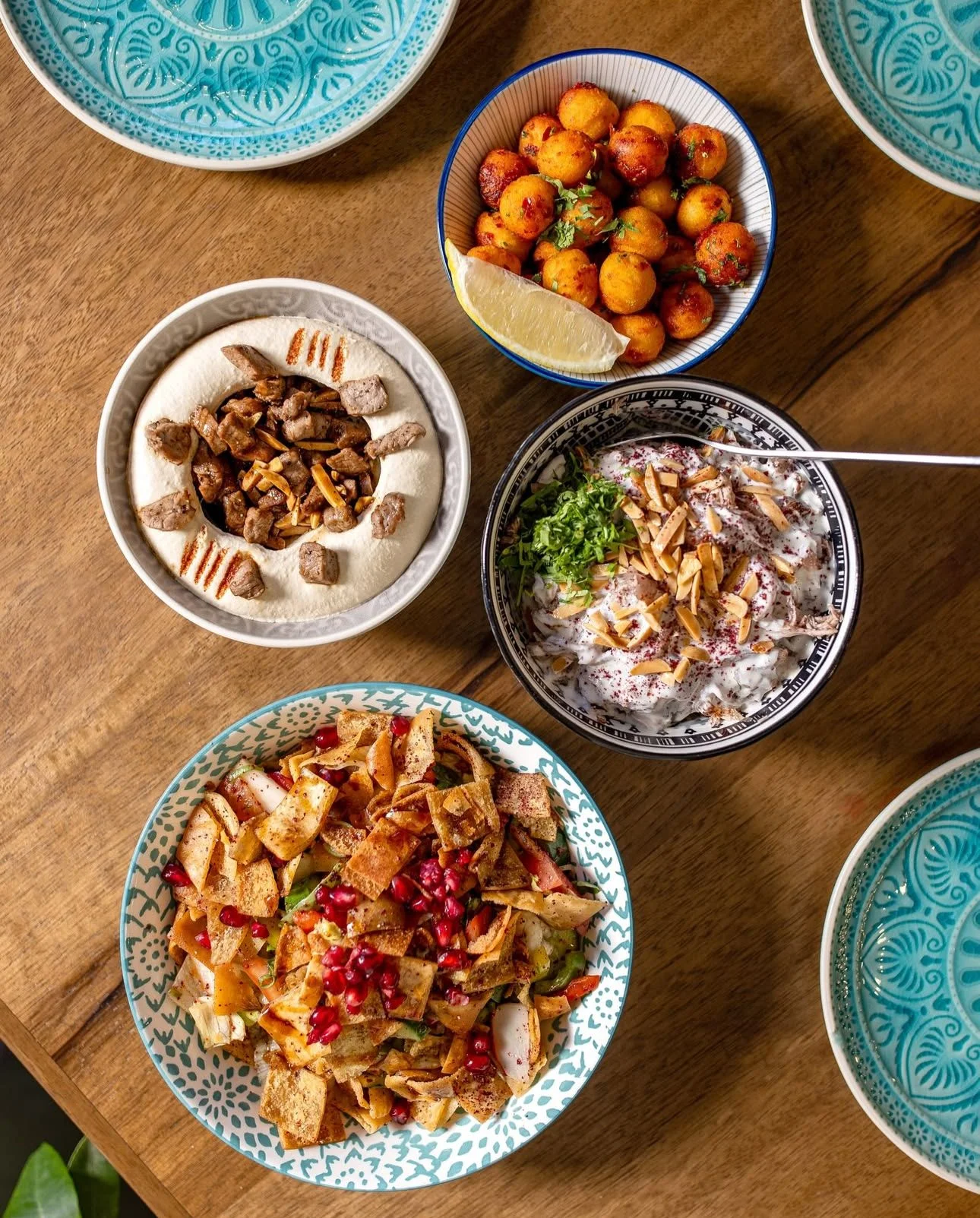 Middle Eastern mezze platter with hummus, salad, and fried potatoes
