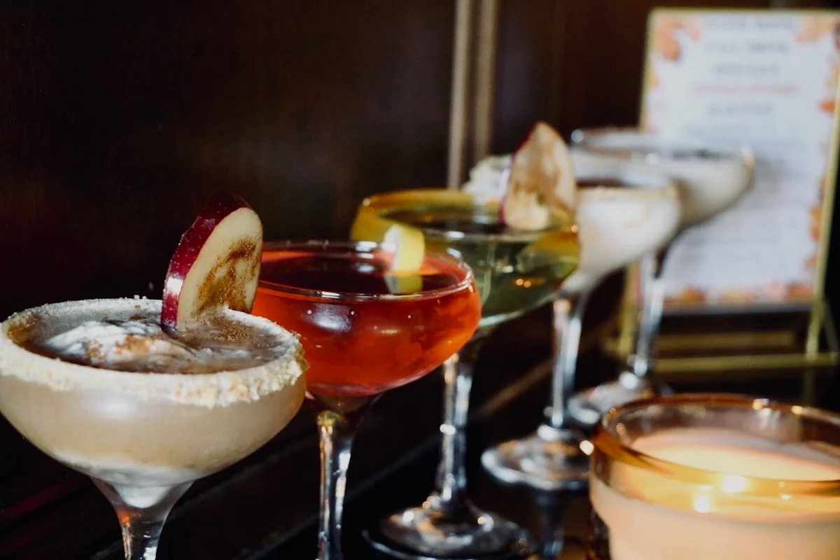 Colorful cocktails lined up at a stylish bar