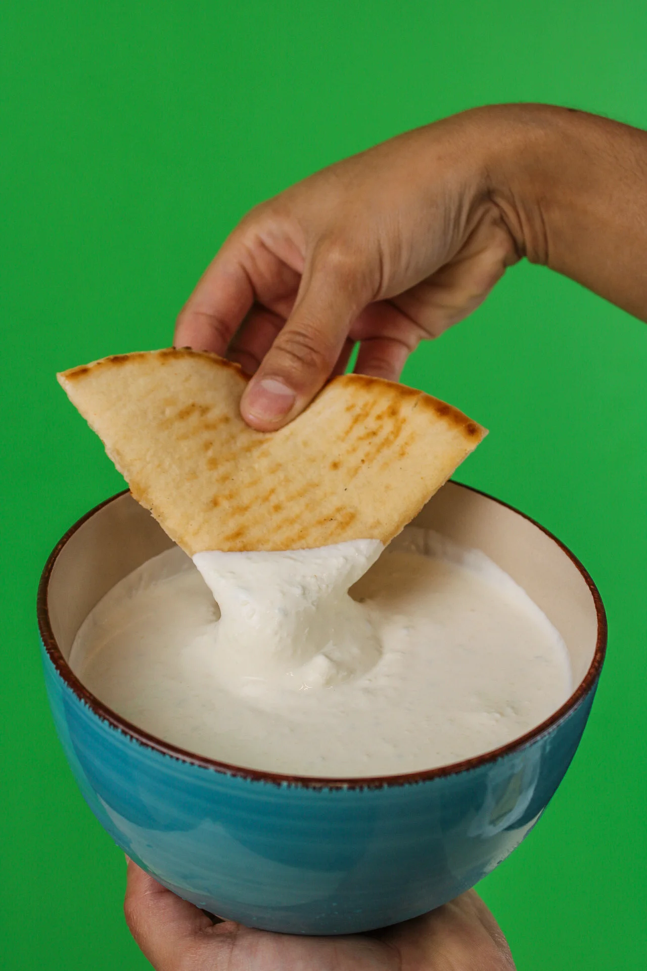Dipping a tortilla in a sauce